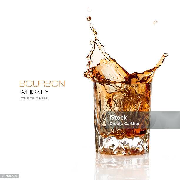 Bourbon Whiskey Splash Isolated On White Background Stock Photo - Download Image Now