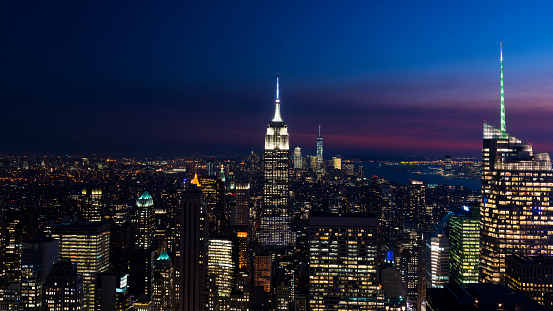 Beautiful skyline of New York City at twilight shot out of a penthouse in the Rockefeller Center.