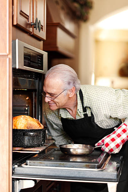 istock Single senior man cooking turkey 617591776