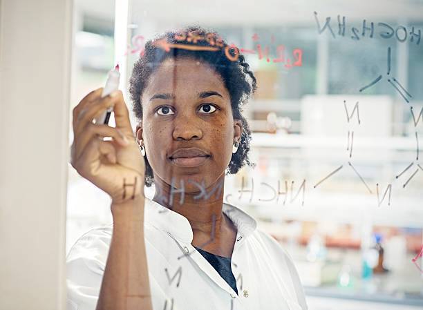 istock Scientist drawing chemical formula on glass in laboratory 617592886