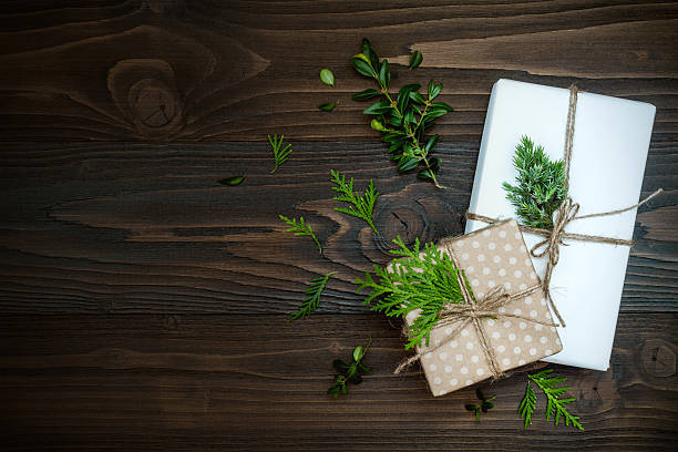 Photo of Christmas background with hand crafted presents  on rustic wooden table