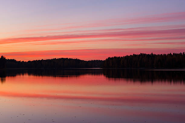 istock Serene view of calm lake and sunset clouds 617593322