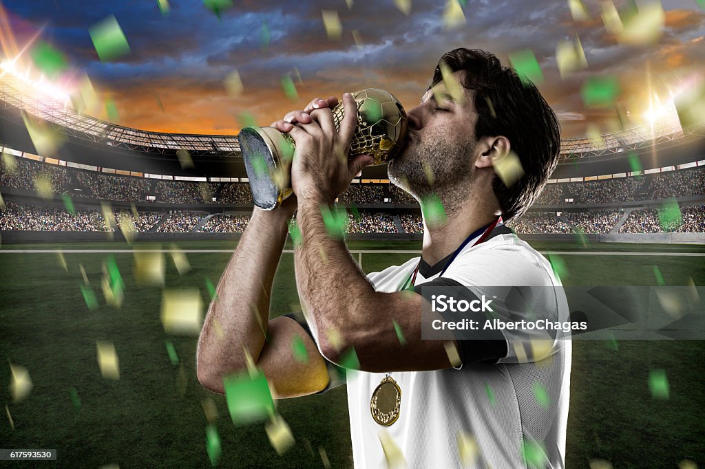 German soccer player German soccer player, celebrating the championship with a trophy in his hand. 2014 Stock Photo