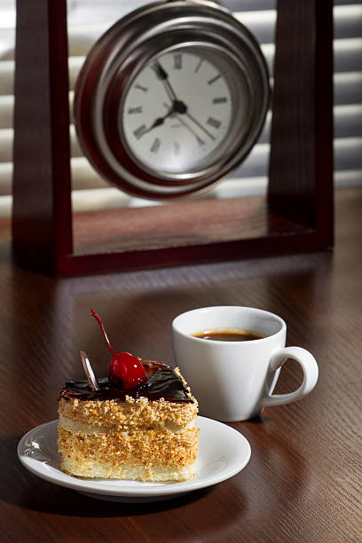 Coffee, cake and watch on a table. Breakfast.