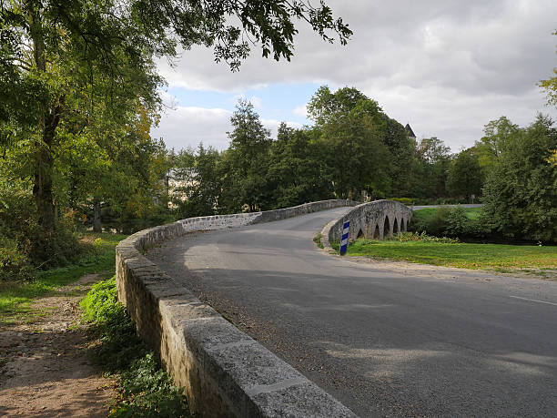 istock French country road with old stone bridge 617594884