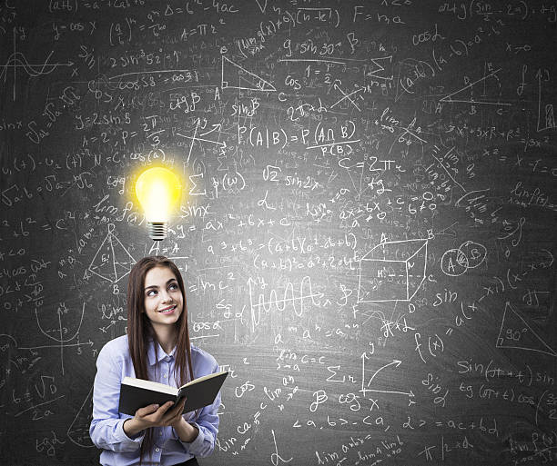 istock Girl with book and light bulb chalkboard 617595104