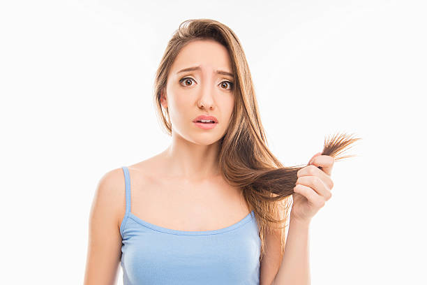 istock Sad unhappy young girl showing her damaged split ends 617596352