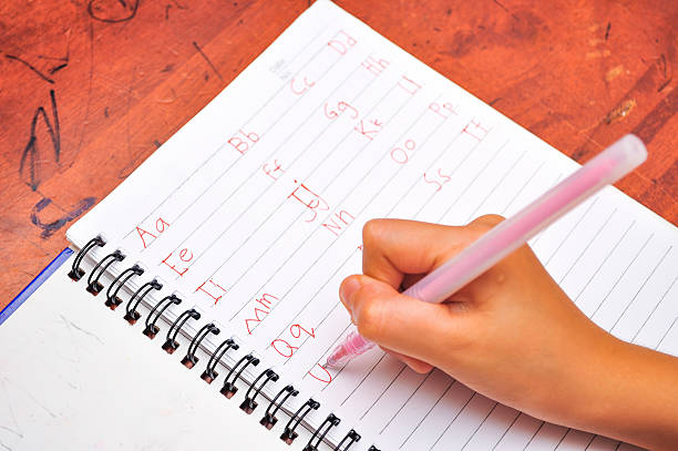 istock Preschool age child writing alphabet 617596684