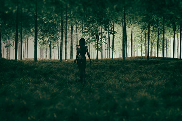 istock Naked woman walking in mysterious forest 617597486