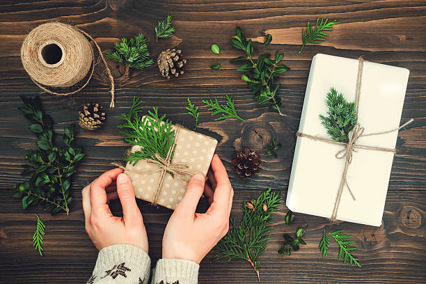 istock Girl wrapping christmas gift. Woman's hands holding decorated gift box 617597688
