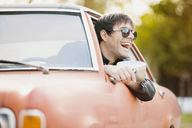 istock Handsome male model posing in car 617598532