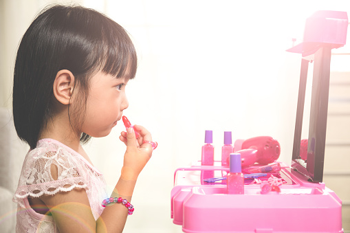 Asian Chinese Liitle Girl Playing With Make-Up Toys At Home