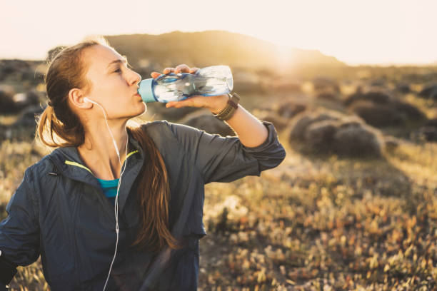 istock Young woman drinking water after workout 617599168