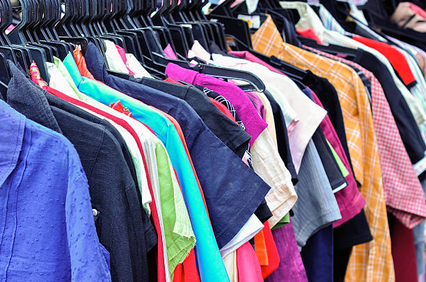 istock Clothes hanging on a rack in a flea market 617599176