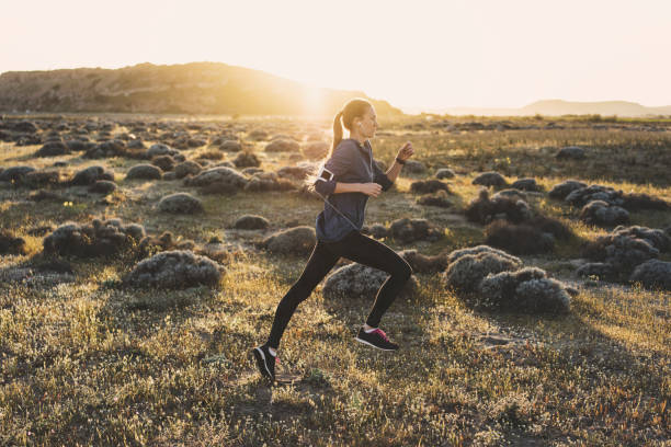 istock Young woman jogging on a sunny day 617599596