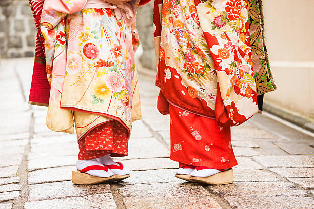 Maiko Apprentice Geisha Japanese Women In Traditional Kimonos Young Japanese women maiko apprentice geisha walking in the historic Gion area of Kyoto, Japan geta sandal photos stock pictures, royalty-free photos & images