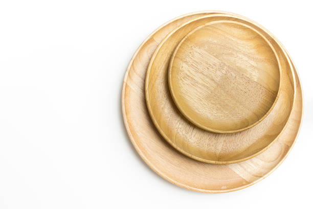 istock Top view wooden plates or trays isolated on white background 617600276
