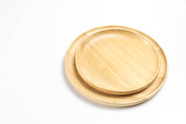 istock Wooden plates or trays isolated on white background 617600536