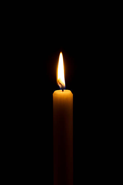 istock burning candle light in a church 617600700