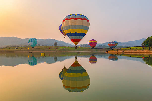 hot air color balloon over lake with sunset time - spy balloon stok fotoğraflar ve resimler