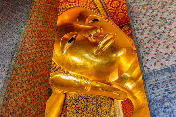 istock Close up Reclining Buddha gold statue 617602504