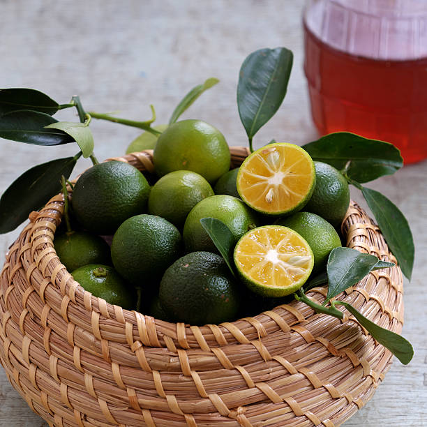 istock Green Kumquat fruit on wooden background 617603334