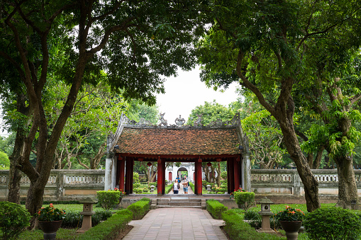 Hanoi, Vietnam - September 20, 2016: Entrance through green garden of temple or literature or first university in Hanoi, Vietnam called Van Mieu - Quoc Tu Giam.