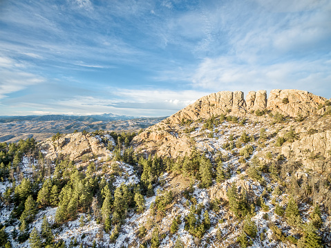 Horsetooth Rock, a landmark of Fort Collins, Colorado, winter scenery with some snow and Rocky Mountains in background