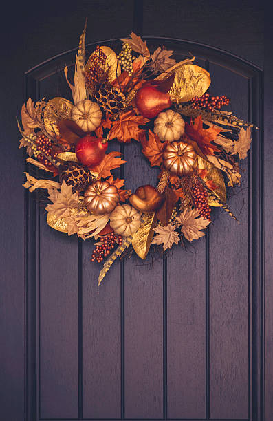 Ornate fall wreath with gold pumpkins hanging on front door