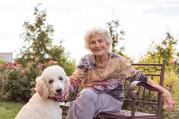 Senior woman playing with dog