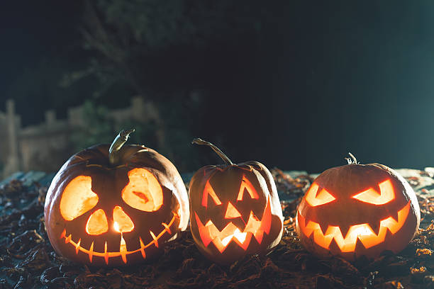istock Halloween pumpkins at wood background. 617608606