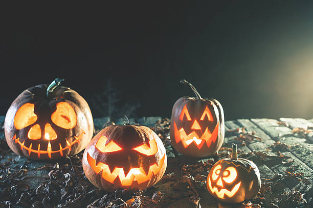 istock Halloween pumpkins at wood background. 617608782