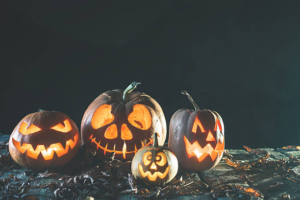 istock Halloween pumpkins at wood background. 617608926