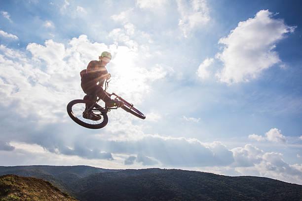 istock Skillful freestyle cyclist doing whip negative trick against the sky. 617733218