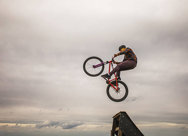 istock Skillful cyclist doing straight air jump against the sky. 617734688