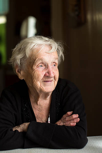 istock An elderly woman sitting at the table. 617735242