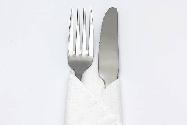 istock Knife and fork with serviette, isolated on the white background. 617735350