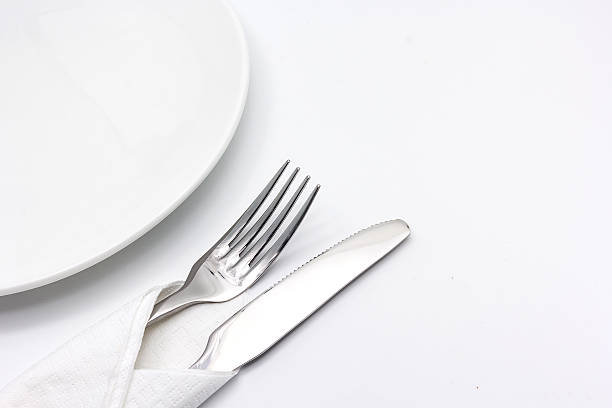 istock Knife and fork with serviette, isolated on the white background 617735730