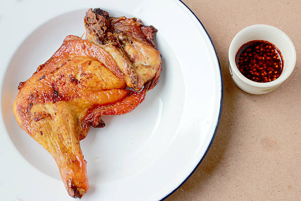 istock grilled chicken legs in white plate with spicy sauce. 617735962