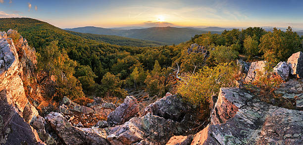 istock Autumn panorama with sun and forest - Slovakia 617736578