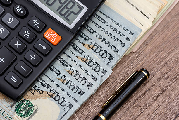 istock pen, money and calculator on desk 617738968