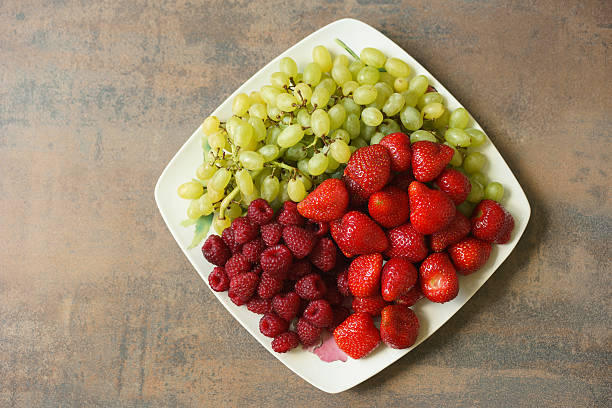 istock Plate with mixture of strawberries, raspberries and grapes 617740466