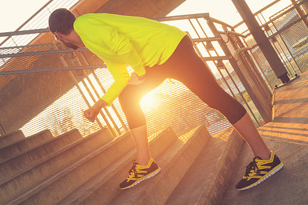 istock Urban jogger on the bridge - stretching after exercise. 617741038