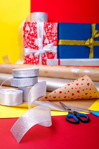 istock Gift wrapping, boxes, paper, ribbon and scissors on color background 617742868