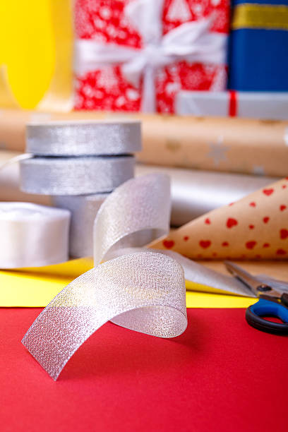 istock Gift wrapping, boxes, paper, ribbon and scissors on color background 617742992