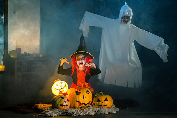 istock Funny Little Witch With Jack-O'-Lanterns 617743084