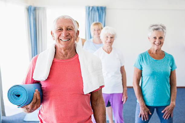 istock Senior man holding yoga mat 617743326