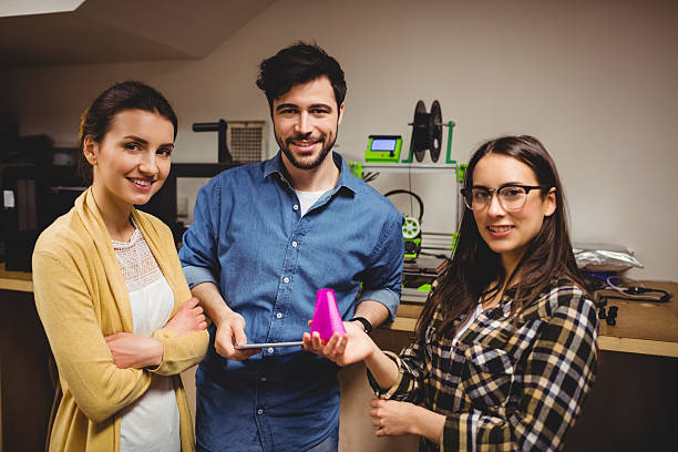 istock Graphic designers standing in office 617743662