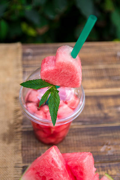 istock Watermelon cocktail with slice on wooden background, outdoors. Close up. 617747128
