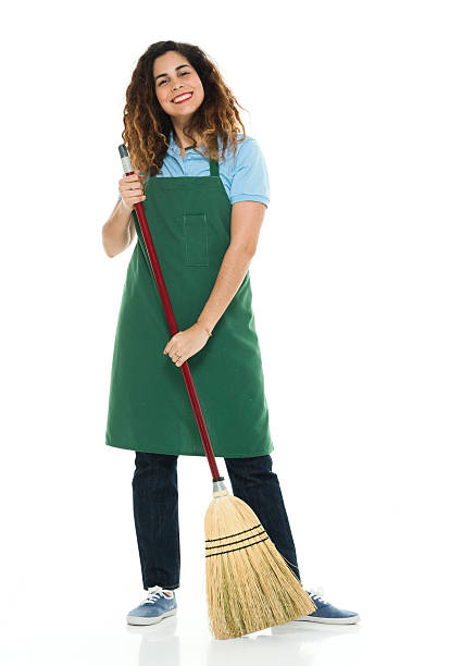 istock Smiling janitor cleaning with broom 617748338